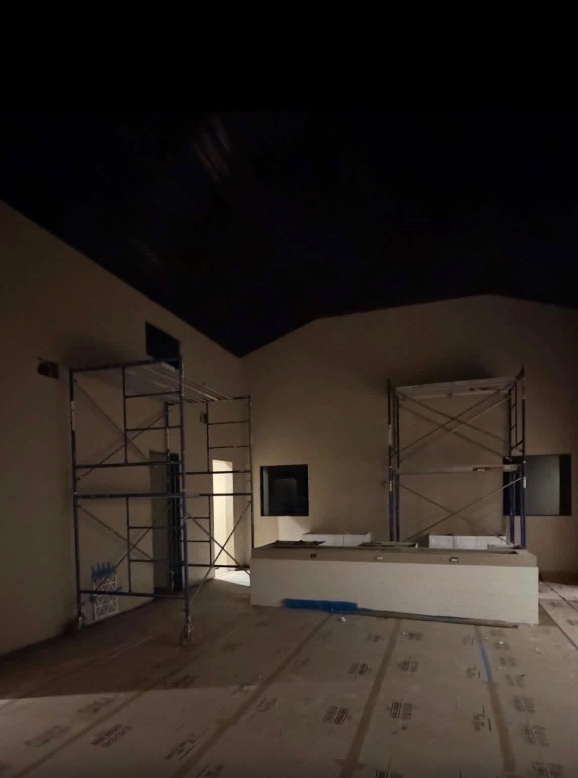 Two scaffold towers set inside a great room for ceiling work