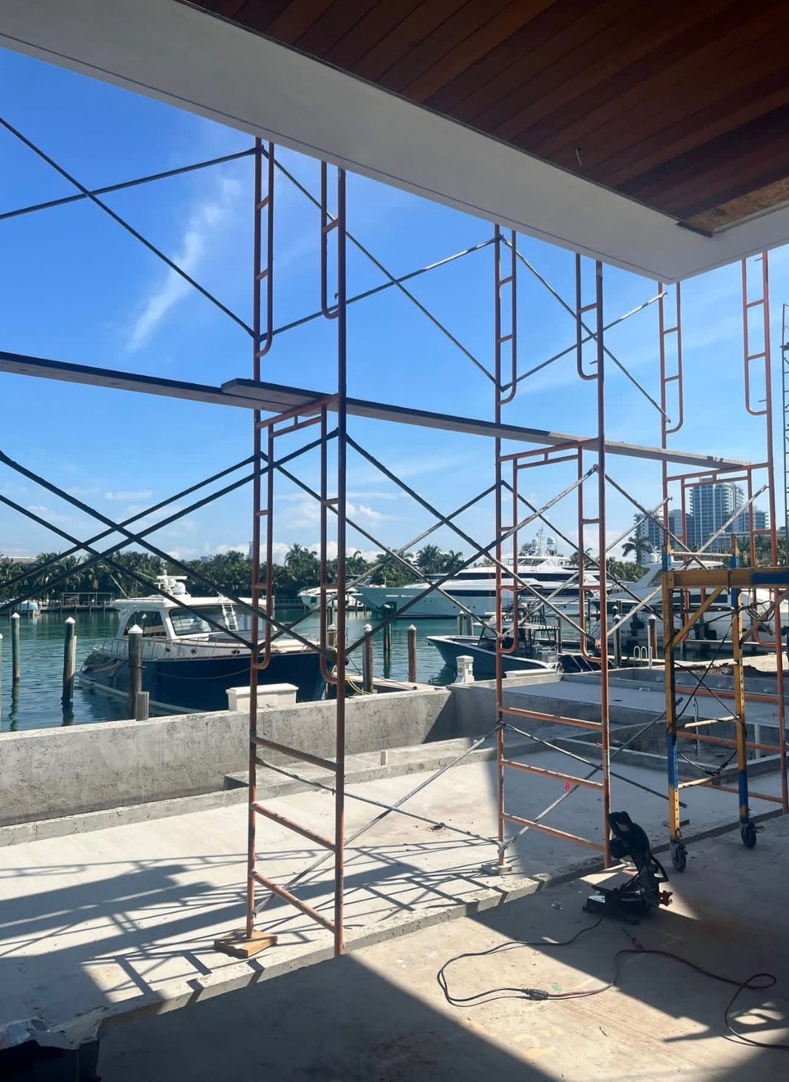 Scaffold set on a waterfront build with marina view